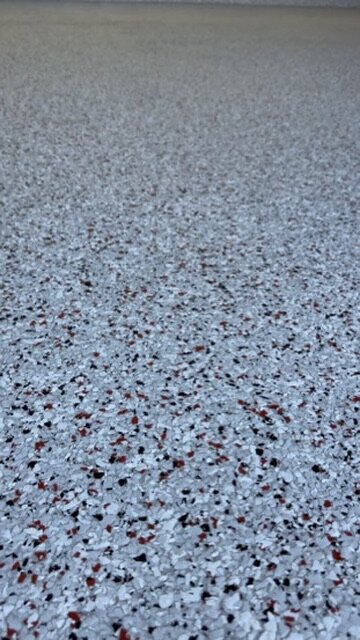 Close-up of red, black and grey flake epoxy blend — Epox It Flooring
